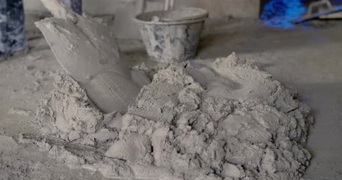 Mixing Cement with Shovel for Construction Project