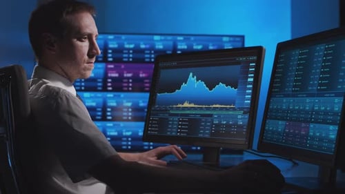 Broker works in office using workstation and analysis technology. Workplace of trader.