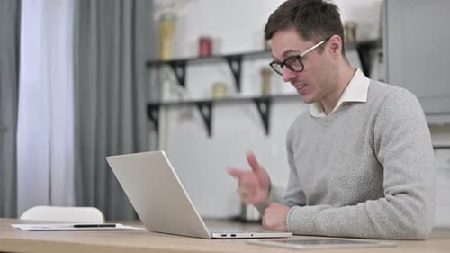 Young Adult Participating in Virtual Meeting at Home