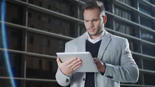 Businessman Working on Digital Tablet in City. Executive Using Touchpad Outside