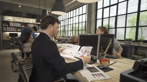 People Working at Computers in Modern Office