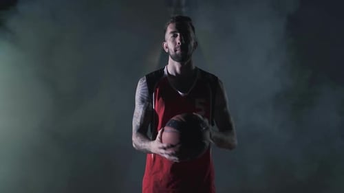 Handsome Young Unshaved Brutal Basketball Player Spin a Ball on Finger