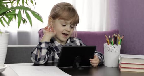 Young Girl Using Tablet for Online Learning at Home