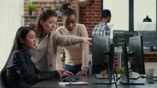 Mixed Team of Programmers Brainstorming Ideas for New Code Library in Front of Computer Screens