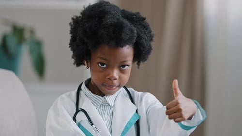 Young Child Doctor Giving Thumbs Up Gesture