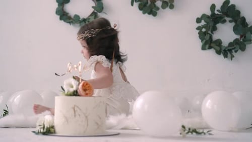 Baby Girl Sitting By Cake with Balloons and Wreaths