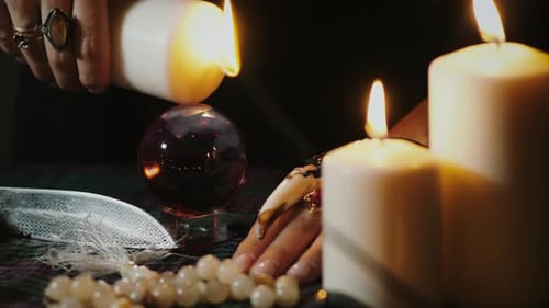 Fortune Teller Pouring Candle Wax on Crystal Ball