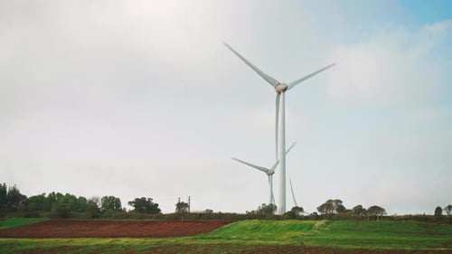 Wind Turbines Rotating in a Rural Field