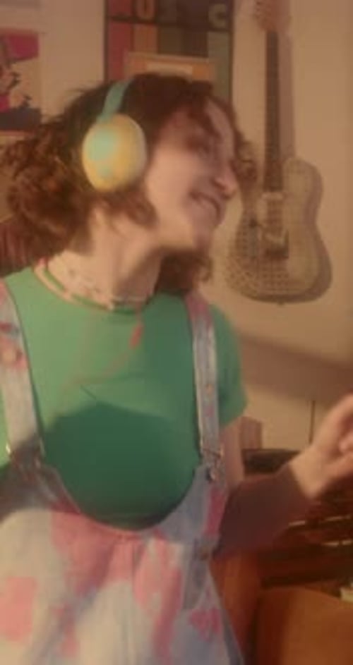 Young Woman Dancing While Listening to Music