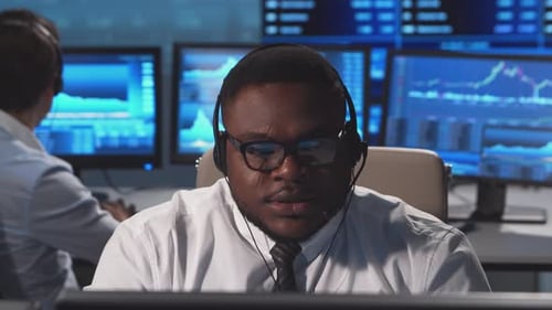 Diverse team of brokers workin in office using workstation and analysis technology.