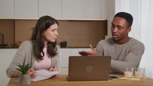African American Tutor is Helping Caucasian Woman Student to Prepare to Pass Exam Learning at Home