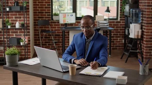 Professional Man on Video Call in Modern Office
