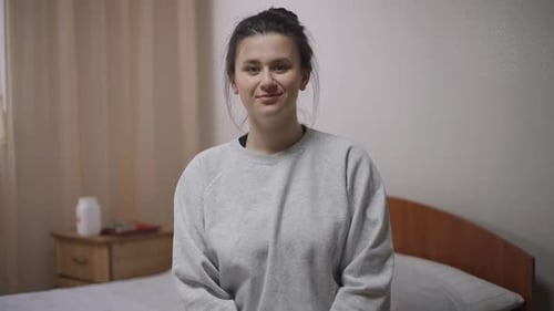 Woman Waving in Bedroom