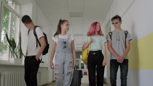 Group of Teenage Students Walking Together Along School Corridor, Schoolchildren Smiling and Talking