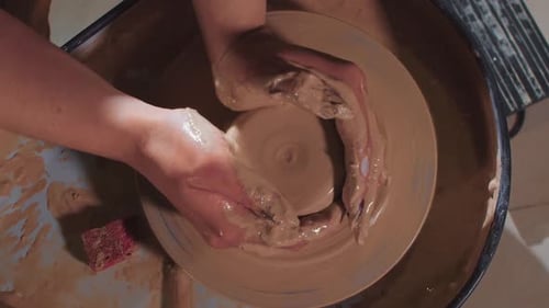 Hands Forming Clay on Pottery Wheel Close Up