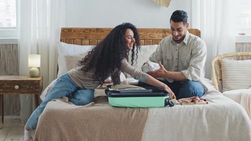 Happy Couple Packing Suitcase for Travel Together