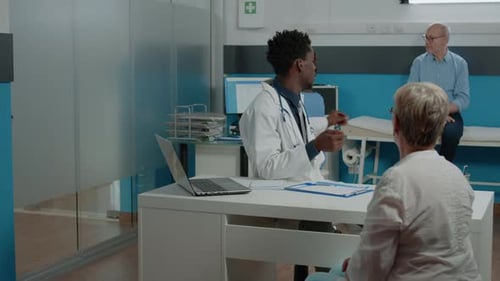 Doctor Explains X-Ray to Patient in Office