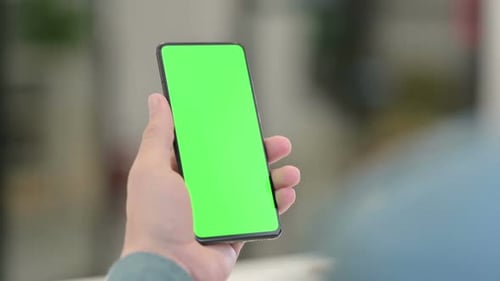 Hand Holding Phone With Green Screen
