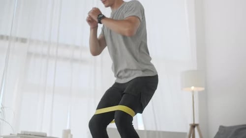 Resistance Band Fitness Man Doing Squat Exercise With Fabric Booty Band Stretching Strap. Male Doing