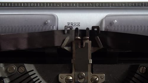Typing word Free on a vintage typewriter. Close up.