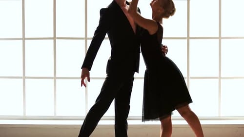 Romantic Young Couple Dancing Gracefully in Studio