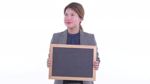 Young Adult Holding a Blank Chalkboard and Smiling