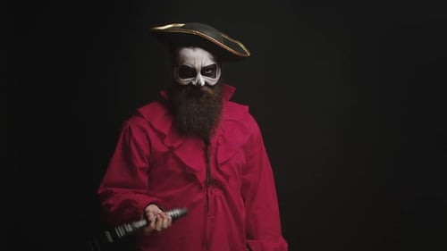 Bearded Pirate in Costume with Skull Makeup Spins Prop