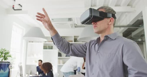 Adult Man Uses VR Headset in Office Setting