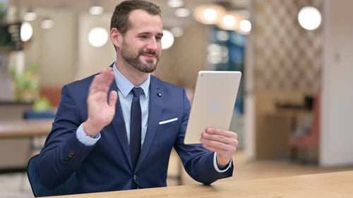 Businessman Video Conferencing on Tablet Device