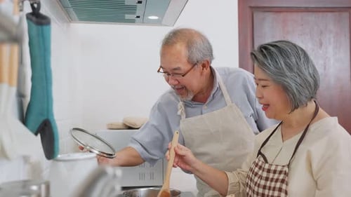 Senior Couple Cooking Together in Sunny Kitchen