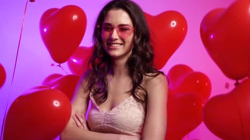 Happy Woman Surrounded by Red Heart Balloons