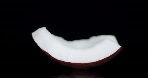 Close-up of Fresh Coconut Wedge on Black