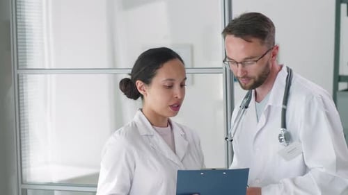 Doctors Discussing Patient Care in Modern Hospital