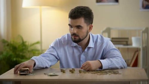 Man Counting Money, Frustrated by Finances