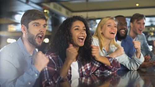 Excited Friends Cheering at Bar Celebration