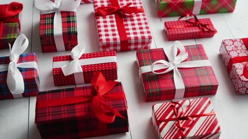Side View of Wrapped Christmas Presents Laid on the Wooden Table