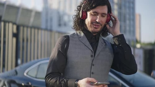 Stylish Man Listens to Music in Urban Setting