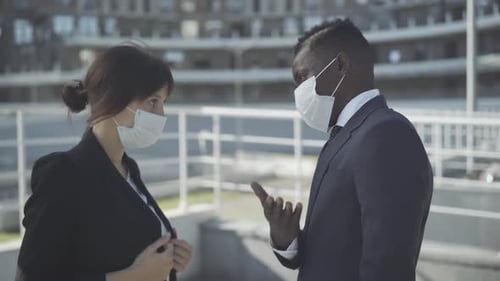 Side View Portrait of Confident Business People in Covid-19 Face Masks Discussing Teamwork Outdoors