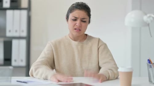 Young Woman Sitting at Desk Suffering from Illness