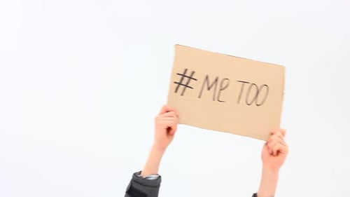 a European Man Holds a Cardboard Box with Handwritten Text on His Outstretched Hands Me Too