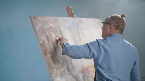 Artist Painting Abstract Art on Canvas in Studio