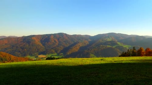 Rolling Hills and Mountain Range in Autumn