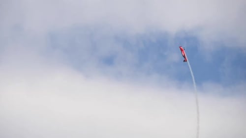 Agile Airplane Performs Loop in Blue Sky