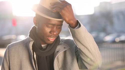 African Man Wear Classical Hat in a City Street