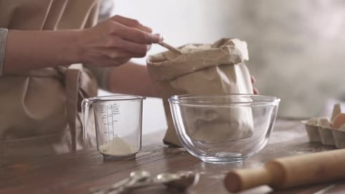 Woman Scooping Flour into Measuring Cup
