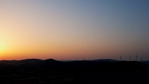 Silhouetted Wind Turbines at Sunrise, Renewable Energy