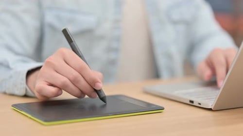 Male Hands Designing with Stylus on Tablet Close Up