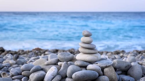 Balanced Stones Stacked Peacefully on a Rocky Beach