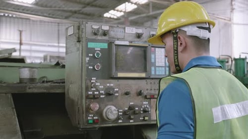 Maintenance engineer control automatic and pressing machine with panel in factory.