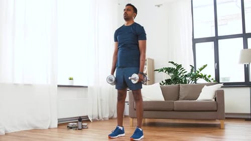 Indian Man Exercising with Dumbbells at Home